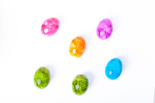 Colorful painted easter eggs laying on white background