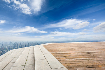 Panoramic city skyline and buildings with wooden square floor in Shanghai,high angle view
