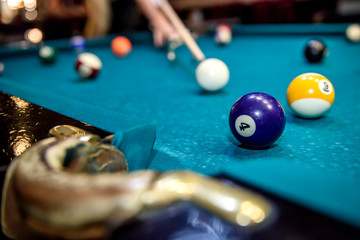 Selective focus at billiard ball on blue table