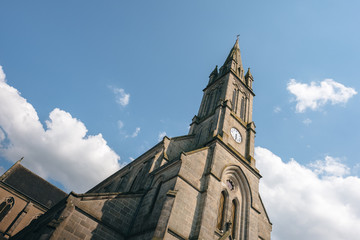Fototapeta na wymiar French church in summer with a beautiful blue sky