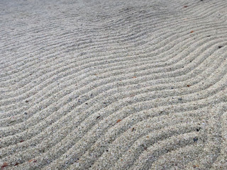 Fototapeta na wymiar pattern of gravel forming waves in a Japanese garden