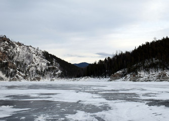 Frozen lake. Beautiful mountain view.  Winter landscape.  The harsh nature of Siberia.
