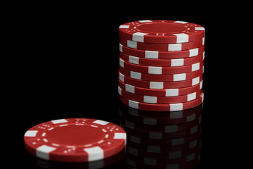 stack of red and white poker chips on a black background close-up