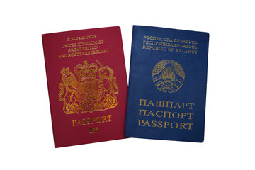 British and Republic of Belarus passports isolated on white background. Doual citizenship concept. Devon, United Kingdom, January, 2019