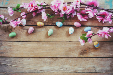 Cherry blossom Artificial flowers and easter egg on vintage wooden background with copy space.