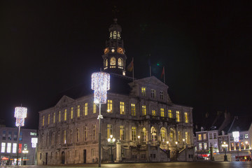 Fototapeta na wymiar Maastricht city hall during evening with illuminated windows