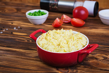 Homemade shepherd's pie on wooden background
