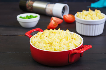 Homemade shepherd's pie on wooden background