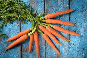 Fresh carrots on a blue table