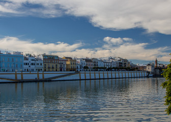 Fototapeta premium The river Guadalquivir in Sevilla, Andalusia, Spain with a view on the popular Calle Betis (English translation: Betis Street) for eating, drinking and going out