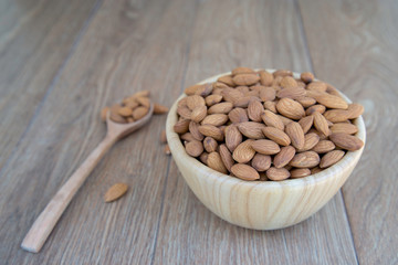 Macadamia nut on wood background.