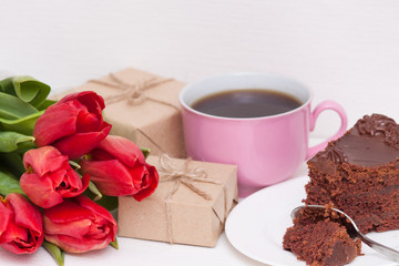Tulips, presents, cake, cup for mother, wife, daughter, girl with love. Happy birthday, Mother's day. Woman's day.