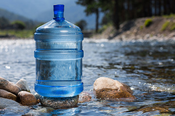 Water big bottle on mountains and rivers background