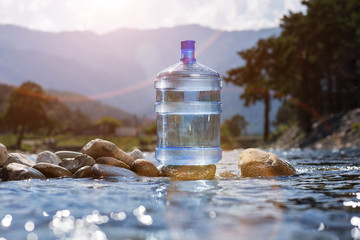 Water big bottle on mountains and rivers background