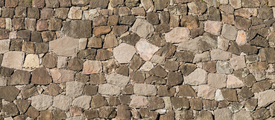 Ancient japanese stone wall made of rocks as background