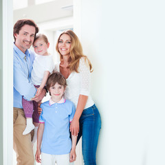 Fototapeta na wymiar Happy family in doorway
