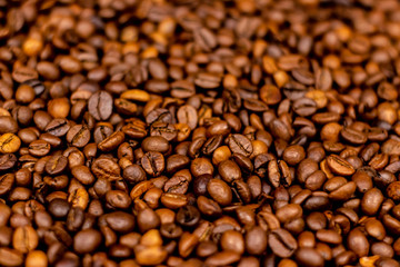 Coffee beans bright saturated texture. Roasted coffee beans background.
