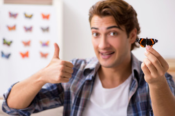 Student entomologist studying new species of butterflies