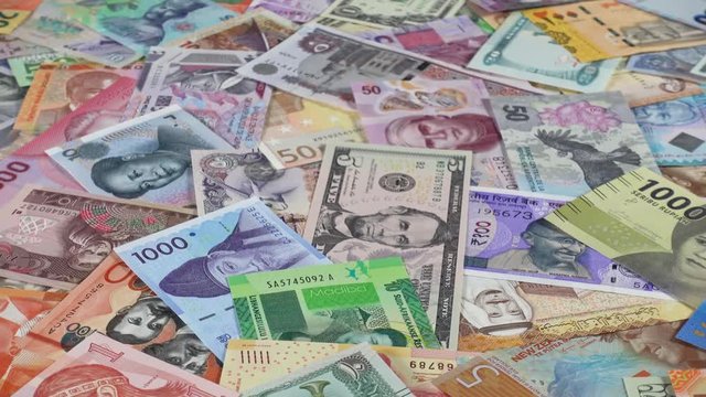 World currencies notes slow rotating. World money, economy. Low angle. 4K stock video footage