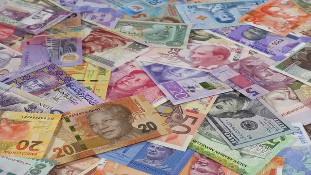 World currencies notes slow rotating. World money. Low angle. 4K stock video footage