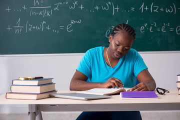 Black female student in front of chalkboard  