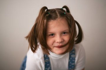 kid girl with funny tails and grimace, Fool's day