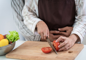 Sweet gay couple preparing food