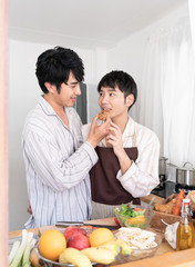 Sweet gay couple preparing food