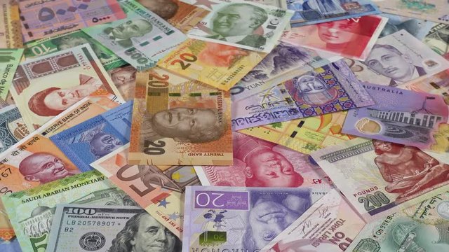 Many world currencies banknotes slow rotating. World money, economy. Low angle. 4K stock video footage