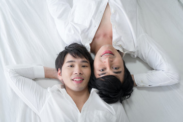 Gay couple spending time in bed