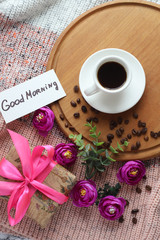 Fototapeta na wymiar a Cup of coffee and croissants with the words Good morning and Hello