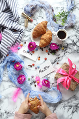 a Cup of coffee and croissants with the words Good morning and Hello