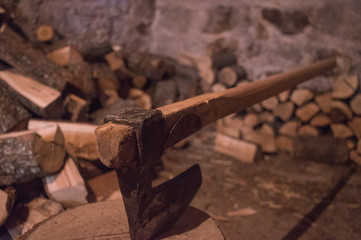 An axe and wood in a basement