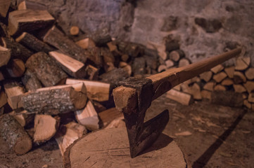An axe and wood in a basement
