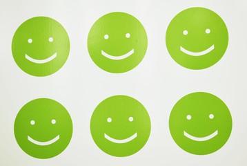 The green smilies on a white background.Celebration, laughable.