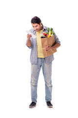 Young man with his grocery shopping on white
