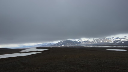 A view from backcountry mountain road F35 in interior highlands of Iceland towards Hofsjokull glacier with very low clouds.
