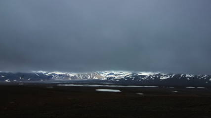 A view of Hofsjokull glacier with very low clouds from backcountry mountain road F35 in interior highlands of Iceland.A view of Hofsjokull glacier with very low clouds from backcountry mountain road F