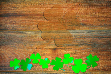 Wooden background with trefoil, shamrock. The symbol of St. Patrick's Day