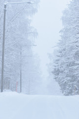 The road number 496  has covered with heavy snow and bad weather in winter season at Tuupovaara, Finland.