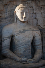 The stone image of Buddha Gautama sitting in dhyana mudra, located near of Polonnaruwa - ancient capital of Sri Lanka.
