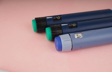 diabetes pen injection needle, syringes lie on pink background, diabetes disease concept, stop...