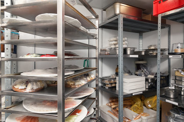 Different foods, fruits and vegetables, greens, pre-cooked dishes on plates in restaurant's warehouse. Concept banquet, catering, preparation, celebration, opening cafe