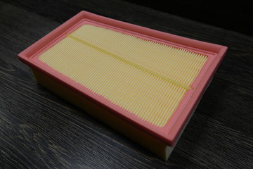 Engine air filter on wooden background