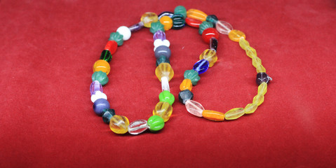 colorful beads on a red background