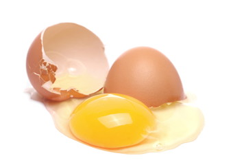 Cracked egg, eggshells with yolk isolated on white background
