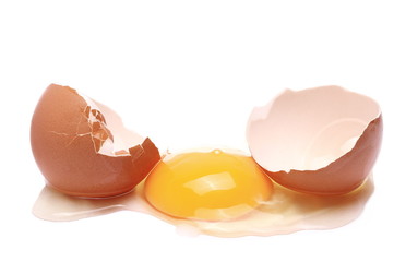 Cracked egg, eggshells with yolk isolated on white background
