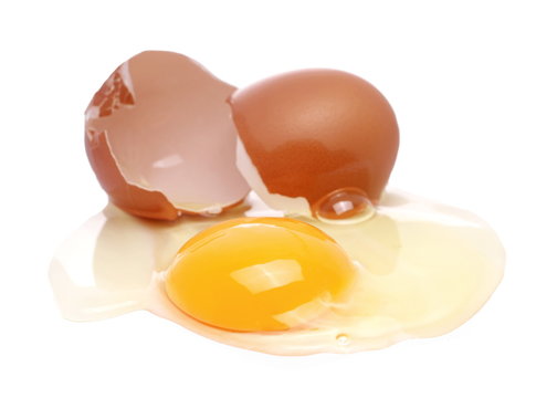 Cracked egg, eggshells with yolk isolated on white background
