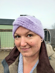 Closeup of mud splattered farm woman wearing head wrap