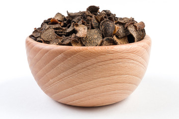 Truffle in wooden bowl isolated on white background. Closeup.